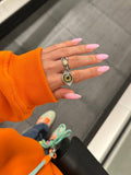 Silver almond eye ring with a hazel hand-painted iris, worn on a hand